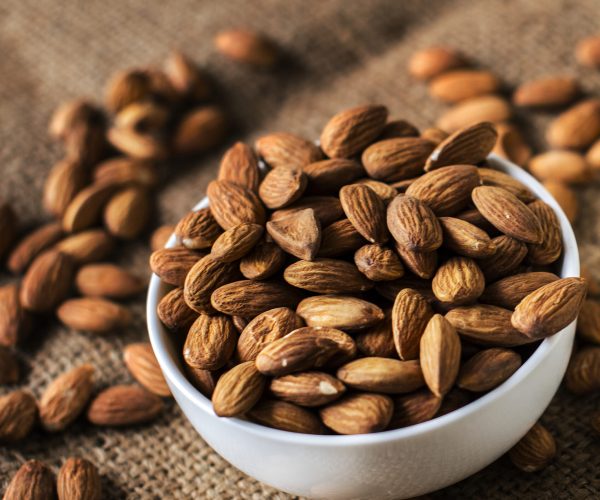 Roasted almonds in a white bowl